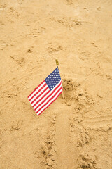 American flag placed in the sand