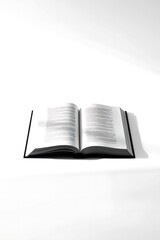 Obraz premium Open book on white surface, ready to be read with natural shadow