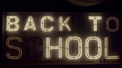Neon 'Back To School' sign glows, perfect for education, learning, promotion, and advertisement projects. Ideal for schools, online courses, educational programs, and event promotions.