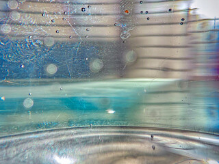A blurry image of a glass with a blue liquid inside