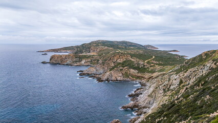 Turquoise sea and rocky shore at Punta Caprara Bay Corsica