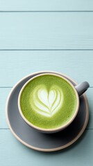 Cup of heart-shaped green matcha latte art.