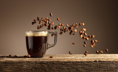 Espresso in glass cup on a old wooden table.