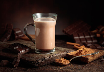Creamy hot chocolate drink on a brown background.