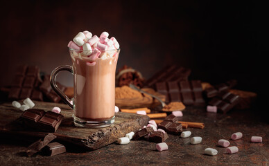 Hot chocolate drink with marshmallows on a brown background.