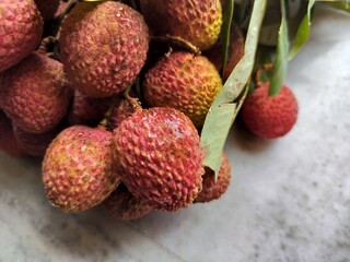 Litchi, also known as lychee or lichee, is a tropical fruit known for its sweet, aromatic flavor and juicy flesh Close display.