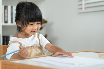 Naklejka premium Portrait Happy Asia children learning and enjoy paint. family is happy and excited in the house. daughter having fun spending time together, Activity, Executive Function, IQ, EQ