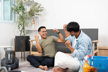 Two joyful men Celebrating Cleaning Success: Happy LGBTQIA Couple