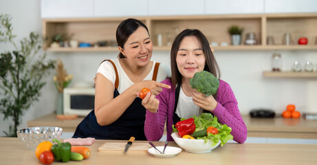 Healthy Cooking Experience. Two women enjoying vibrant vegetables in a bright kitchen.