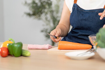 Healthy Cooking and Meal Prep. A person chopping fresh vegetables in a modern kitchen.