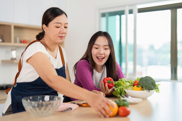 Healthy Cooking Together. Two friends excitedly preparing vegetables in a bright kitchen.