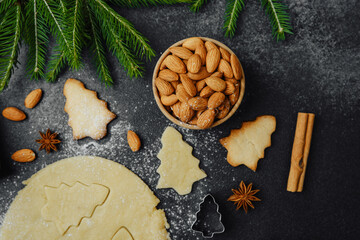 Christmas almond cookies and dough with fir branches and spices for holiday food styling concept