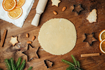 Festive cookie dough and baking setup on wooden table for christmas culinary and rustic food concept