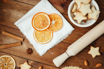 Dried orange slices with festive baking setup for christmas culinary styling and seasonal food...