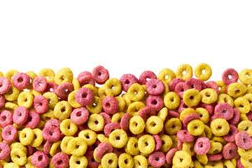 corn rings and strawberry rings in a white background, close up, top view. Crispy cereal loops in a white background.