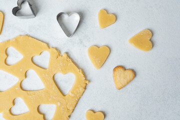 Heart shaped cookies with cinnamon and raw dough for baking or valentines day concept