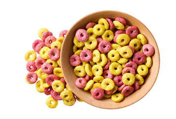 corn rings and strawberry rings pouring out of wooden bowl isolated on white background. Top view....