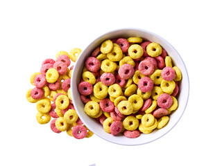 corn rings and strawberry rings pouring out of ceramic bowl isolated on white background. Top view....