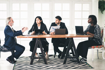 Successful business contract dealing with young smart businessman entrepreneur and senior manager male in meeting room at workplace, two businessmen shaking hands happy joint venture business together