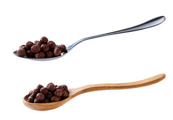 chocolate corn balls in a metal spoon isolated on white background.
