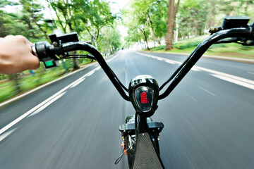 Riding on high speed electric bicycle in park