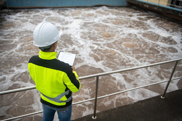 A wastewater treatment engineer is inspecting the operation of a water treatment plant