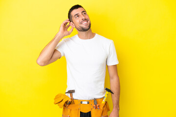 young electrician caucasian man isolated on yellow background thinking an idea