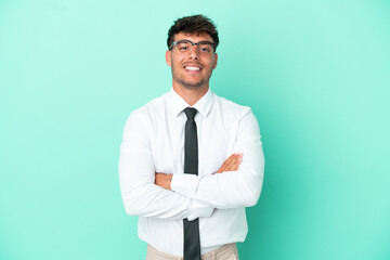 Business caucasian man isolated on blue background keeping the arms crossed in frontal position