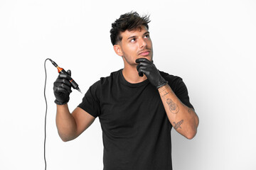 Tattoo artist caucasian man isolated on white background and looking up