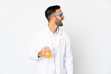 Young scientific man isolated on white background laughing in lateral position