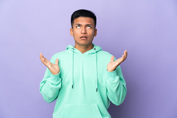 Young Ecuadorian man isolated on purple background stressed overwhelmed