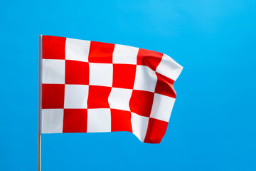 Checkered flag waving on blue background