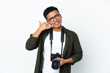Young Ecuadorian photographer isolated on white background making phone gesture. Call me back sign
