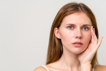 Fototapeta premium Portrait of pretty young woman over isolated white background