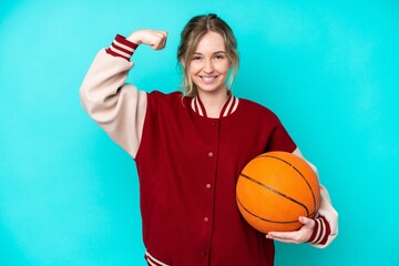 young basketball player caucasian woman isolated on blue background doing strong gesture