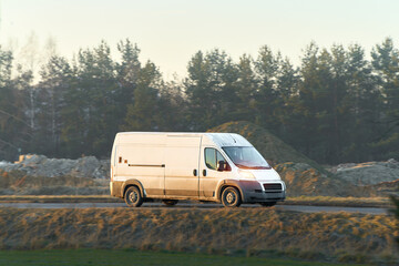 White cargo van driving on open road