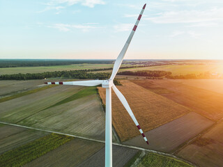 Wind turbines on farmland at sunset