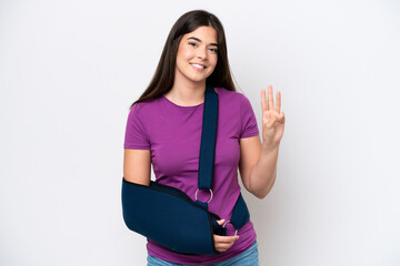 Young Brazilian woman with broken arm and wearing a sling isolated on white background happy and...