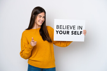 Young Brazilian woman isolated on white background holding a placard with text Believe In Your Self...
