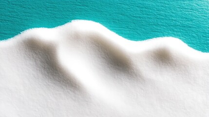 Rippled White Snow Surface in Soft Light Against Teal Background