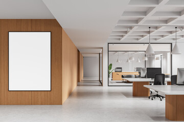 Modern open space office interior with wooden wall and blank vertical poster mockup on light floor and minimalist furniture setup. 3D Rendering