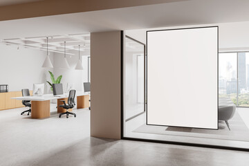 Modern open office interior with blank vertical screen and panoramic city view window in a bright...