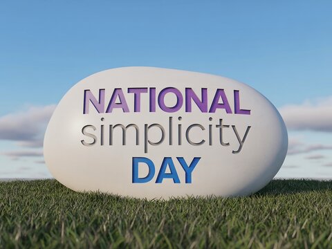 National simplicity day celebrated with carved text on a smooth stone against a blue sky and green grass