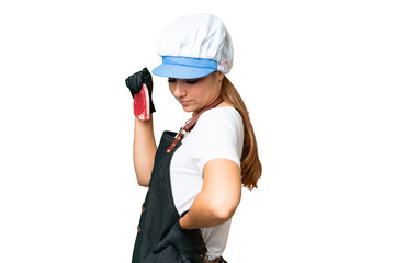 Butcher woman wearing an apron and serving fresh cut meat over isolated chroma key background...