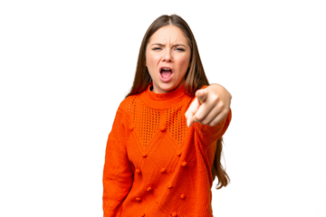 Young blonde woman over isolated chroma key background frustrated and pointing to the front