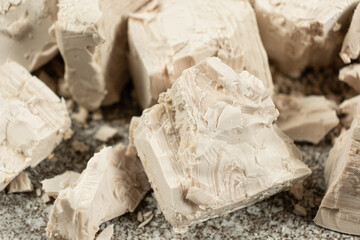 Compressed fresh yeast cubes close-up
