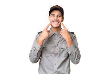 Young security man over isolated background smiling with a happy and pleasant expression