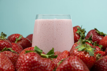 Freshly made strawberry milkshake with milk, ice cream and strawberries.