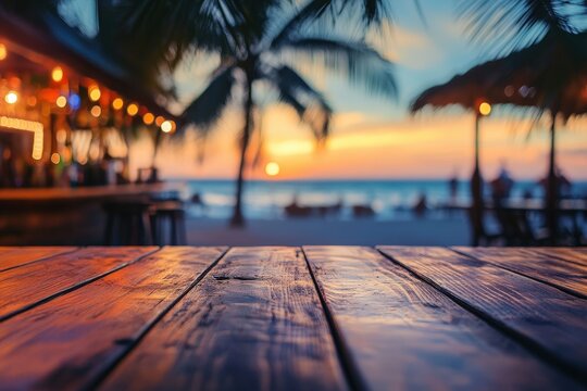 Wooden table at a beachside bar at sunset.