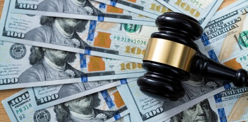 Gavel on stack of dollars